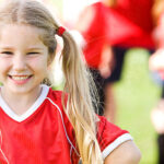 Child in Soccer Jersey Smiling