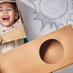 Child Wearing Cardboard Rocket Costume
