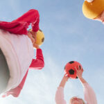 Children Holding Soccer Balls Overhead